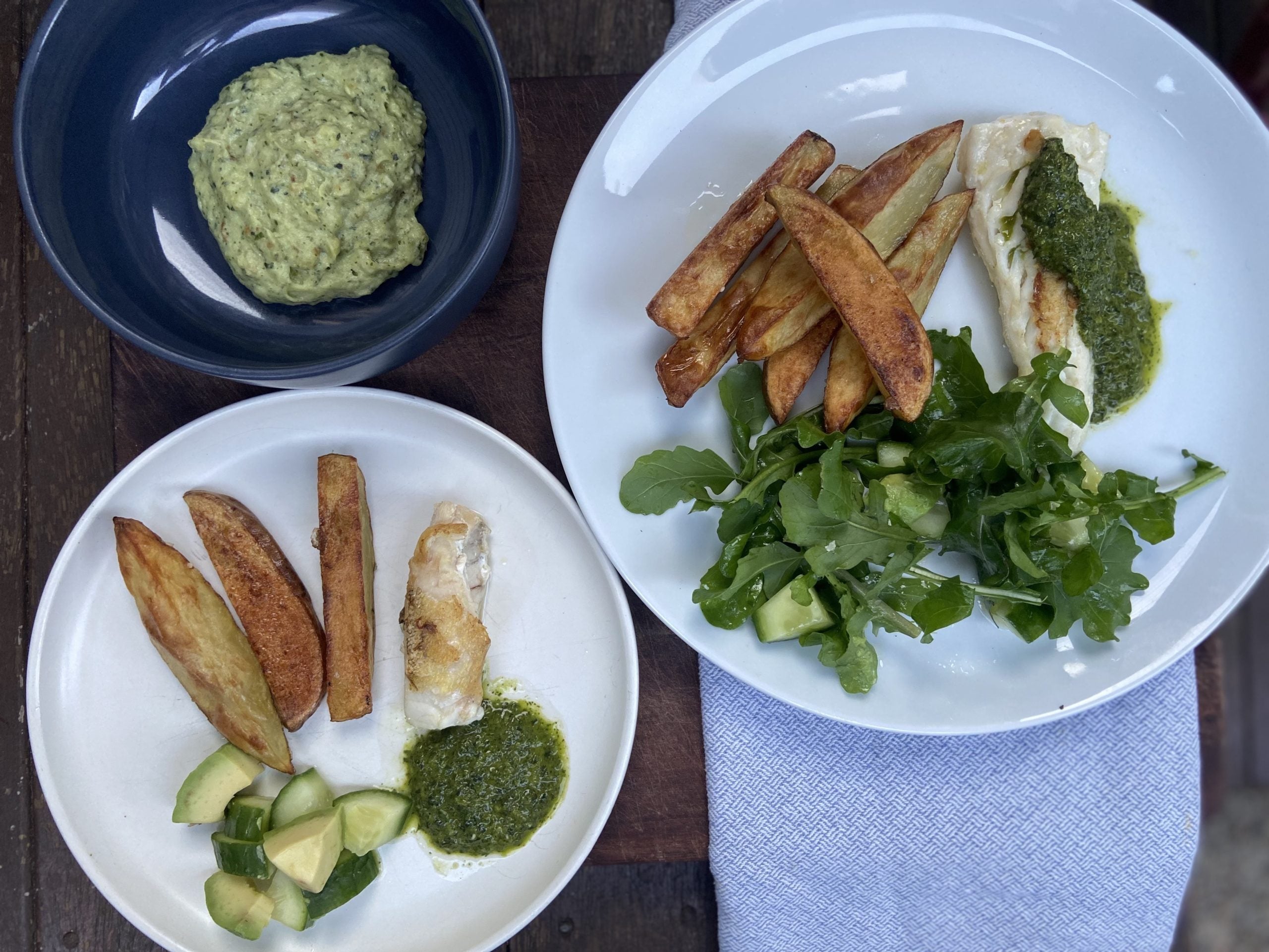 Wholesome fish and chips with green sauce and salad