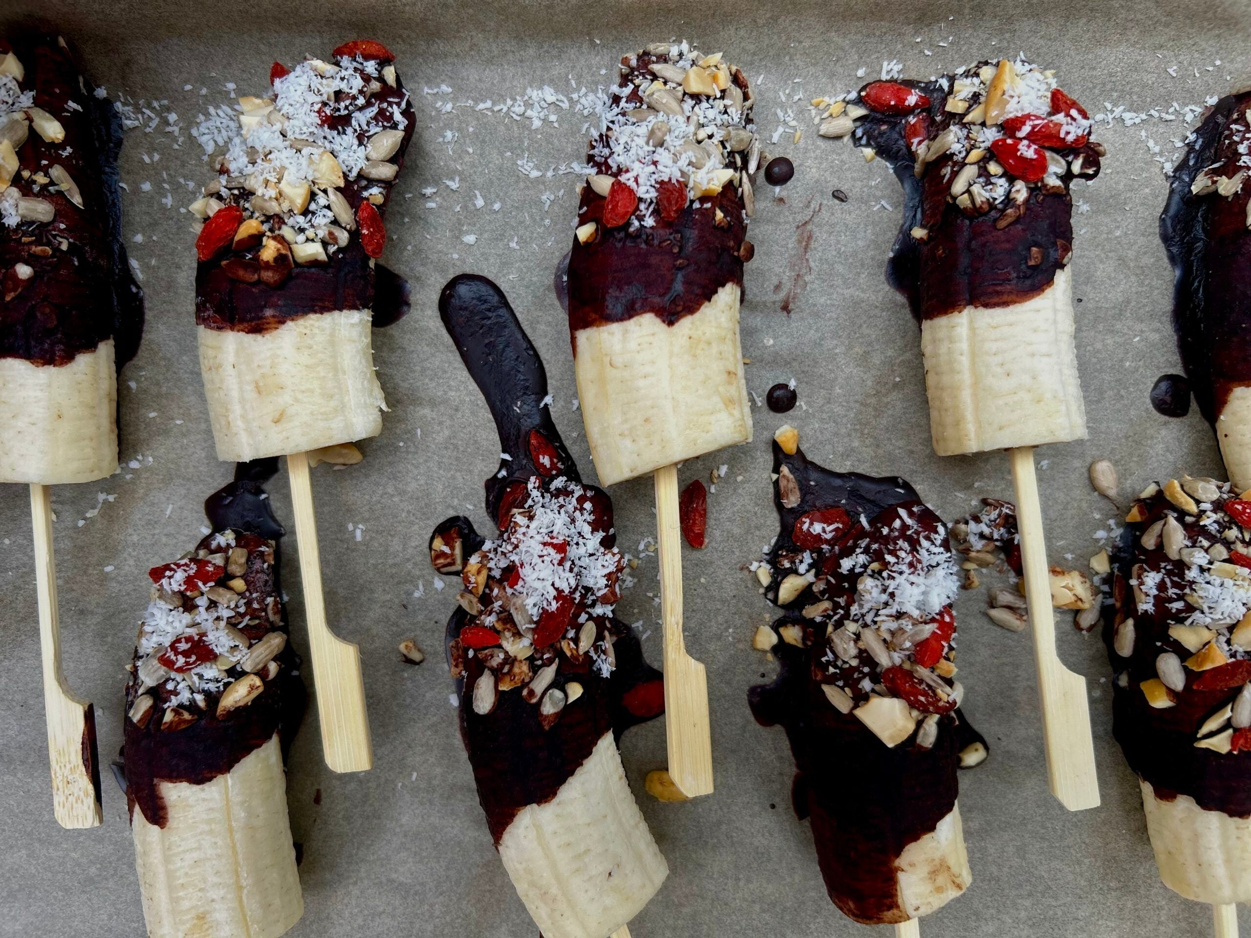 Chocolate coated bananas with nuts, seeds and coconut